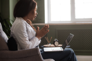 a patient uses a laptop to research the Benefits of Seeking a Medical Second Opinion